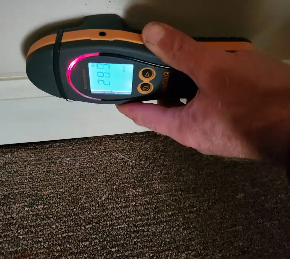 Moisture detection at baseboard during Storm Damage Restoration in Laketown